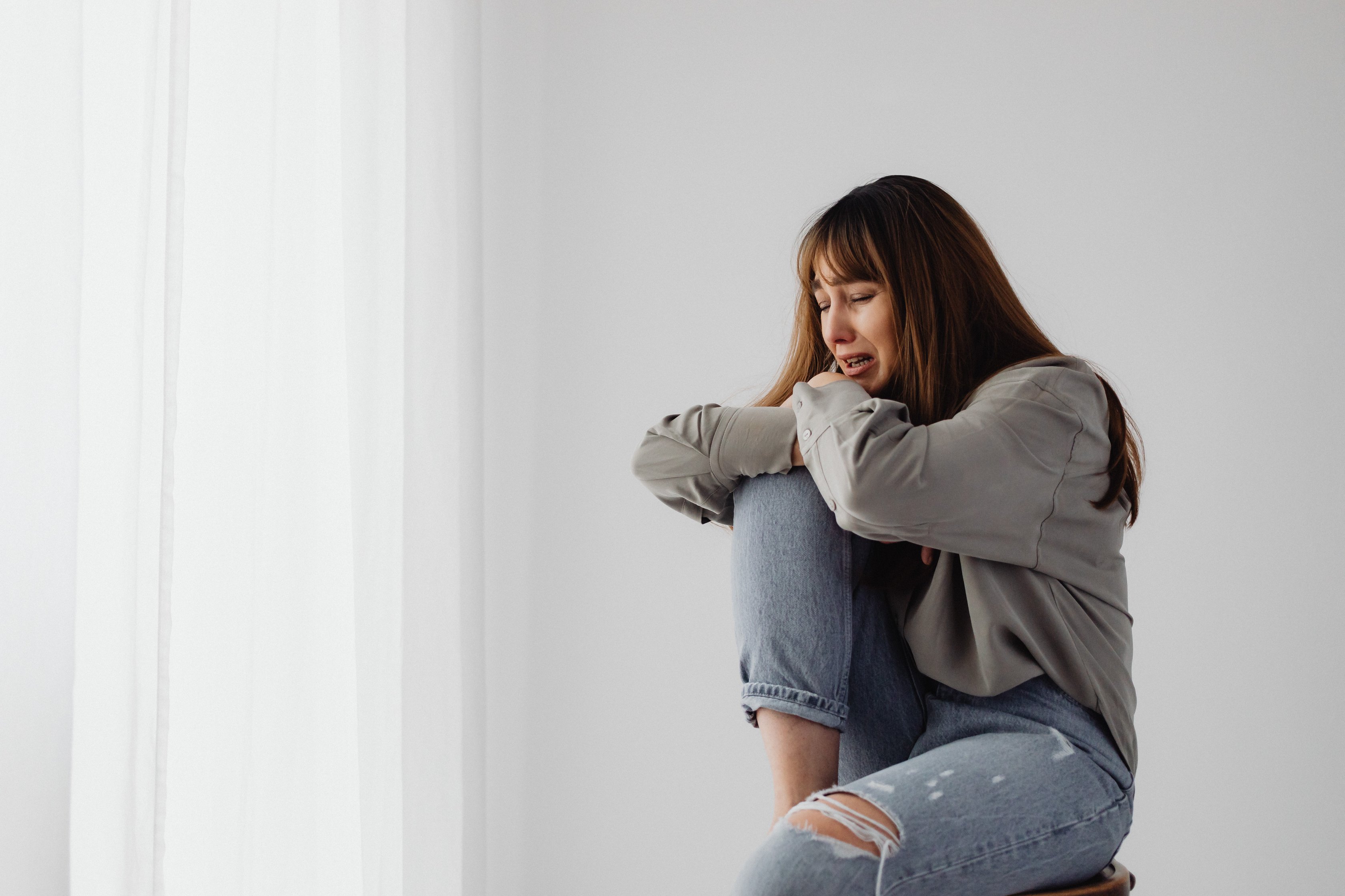 Woman Sitting and Crying